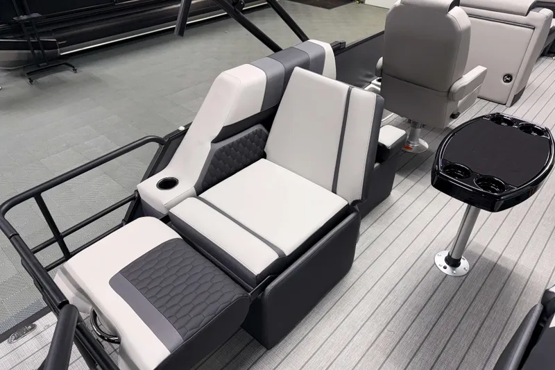 Slide: The Image of 2026 Sylvan L1 LZ boat interior with modern seating and sleek table design. - 9