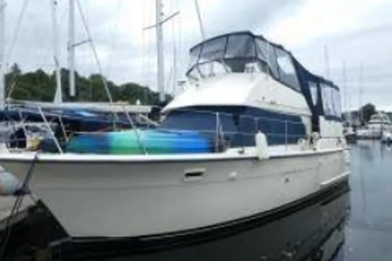 The Image of 1972 Hatteras 38 Double Cabin yacht docked at marina, featuring classic design. - 1
