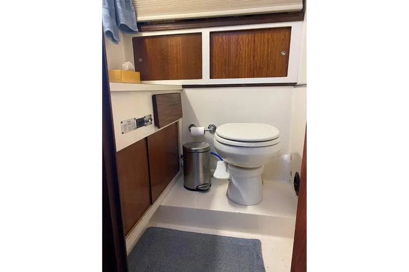 Slide: The Image of 1972 Hatteras 38 Double Cabin bathroom with wooden cabinets and toilet. - 11