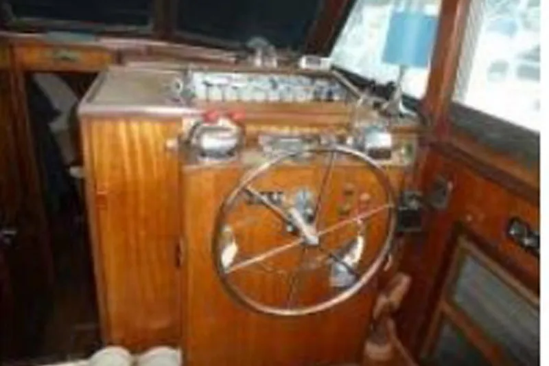 Slide: The Image of Interior helm of 1972 Hatteras 38 Double Cabin with wooden finish and steering wheel. - 14