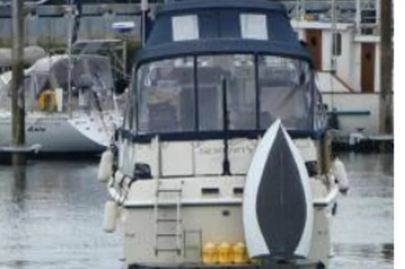 Slide: The Image of 1972 Hatteras 38 Double Cabin yacht docked in a marina. - 16