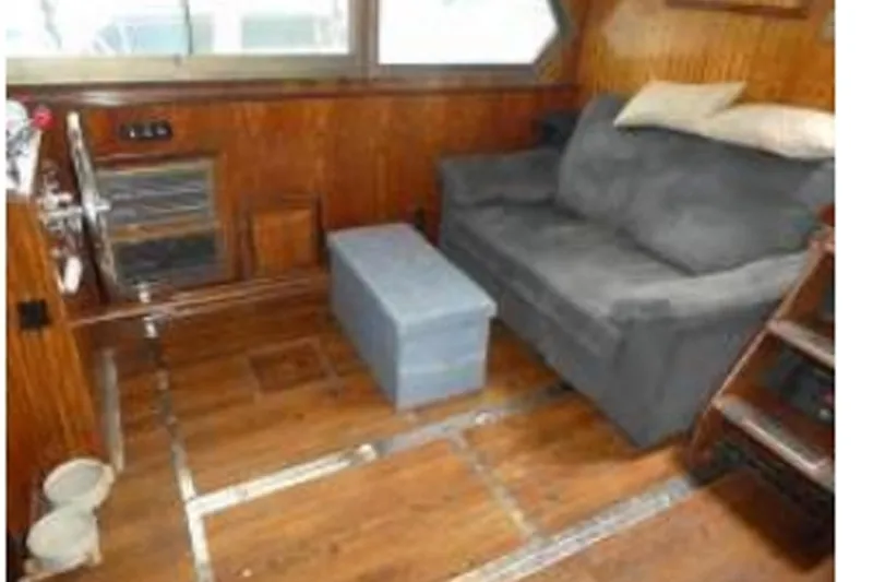 Slide: The Image of Interior of 1972 Hatteras 38 Double Cabin with wooden paneling and gray sofa. - 3