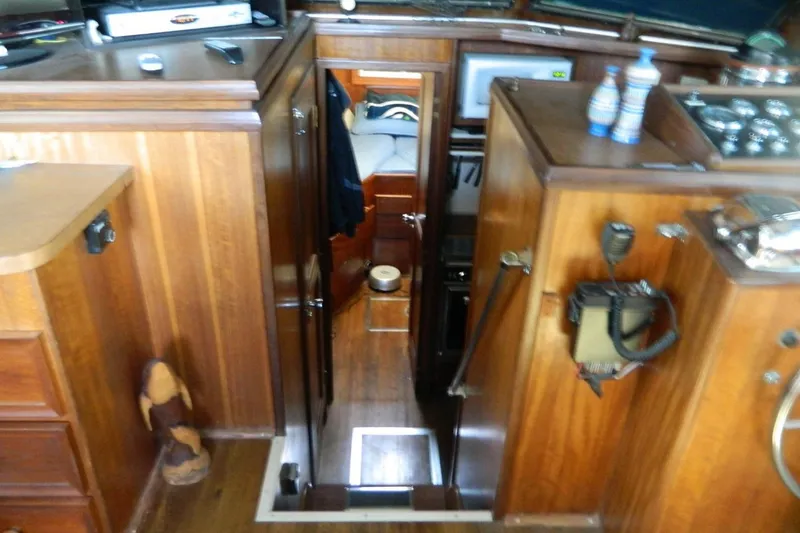 Slide: The Image of Interior view of a 1972 Hatteras 38 Double Cabin with wooden finishes and nautical equipment. - 4