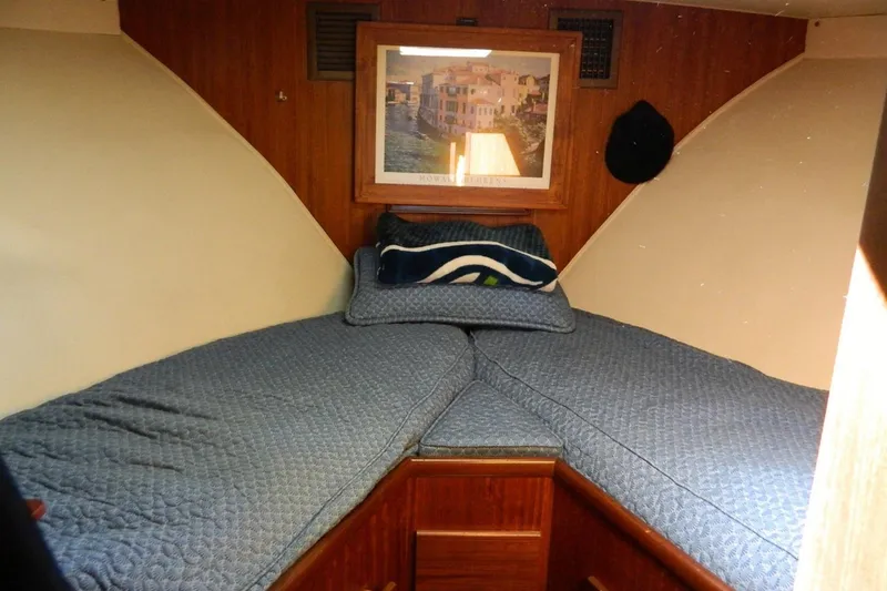 Slide: The Image of Cozy cabin interior of 1972 Hatteras 38 Double Cabin with blue bedding and framed artwork. - 9