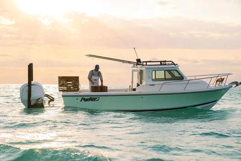 The Image of Manufacturer Provided Image: 2026 Parker 247 Explorer boat on water at sunset, person onboard, Yamaha engine visible. - 0