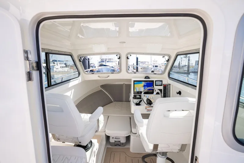 Slide: The Image of Manufacturer Provided Image: Interior of 2026 Parker 247 Explorer boat with modern navigation equipment and seating. - 4