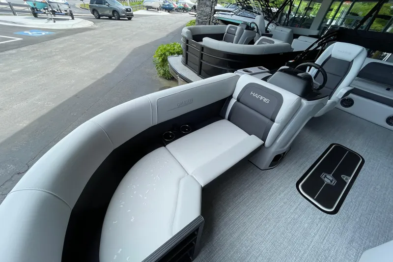 Slide: The Image of 2026 Harris Cruiser 210 SLDH pontoon boat interior with plush seating and modern design. - 13