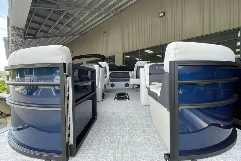 Slide: The Image of 2026 Harris Cruiser 210 SLDH pontoon boat with spacious seating under a covered dock. - 15
