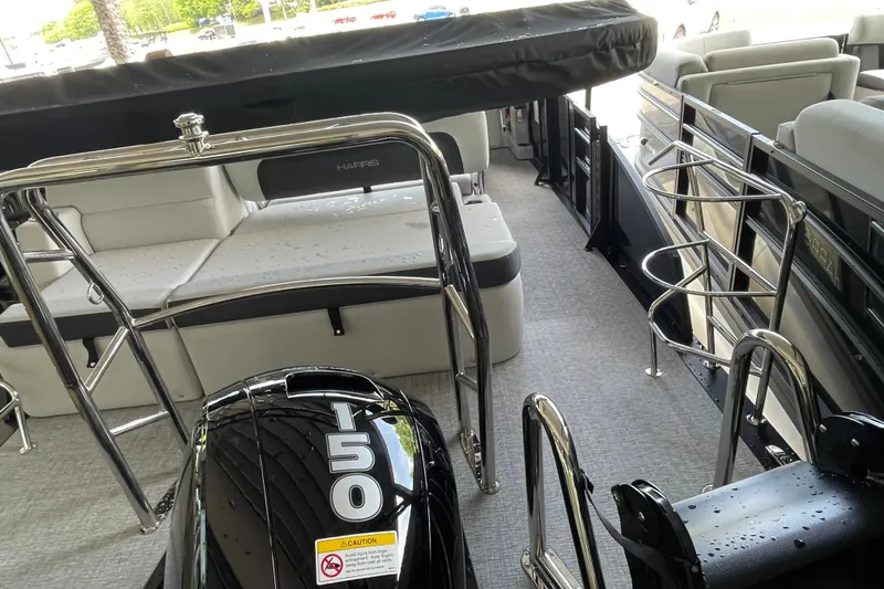 Slide: The Image of 2026 Harris Cruiser 210 SLDH pontoon boat interior with seating and 150 HP engine. - 17