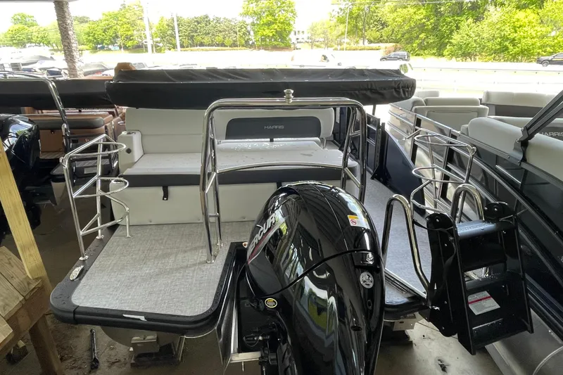 Slide: The Image of 2026 Harris Cruiser 210 SLDH pontoon boat with sleek design and powerful outboard motor. - 18