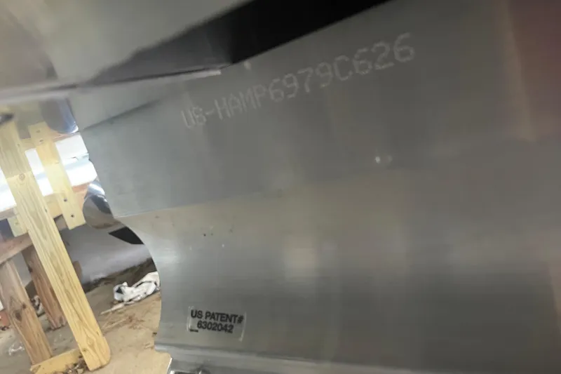 Slide: The Image of Close-up of 2026 Harris Cruiser 210 SLDH hull with patent number visible. - 20