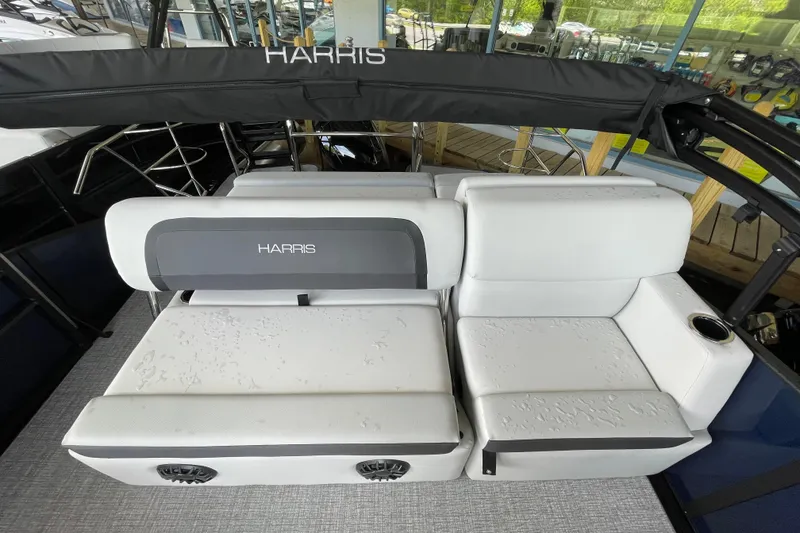 Slide: The Image of 2026 Harris Cruiser 210 SLDH boat interior with white cushioned seating and cup holder. - 5