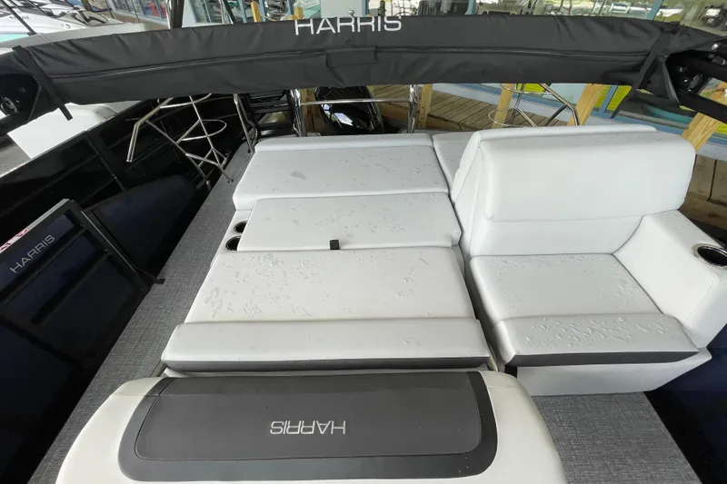 Slide: The Image of 2026 Harris Cruiser 210 SLDH boat interior with white seating and sleek design. - 7