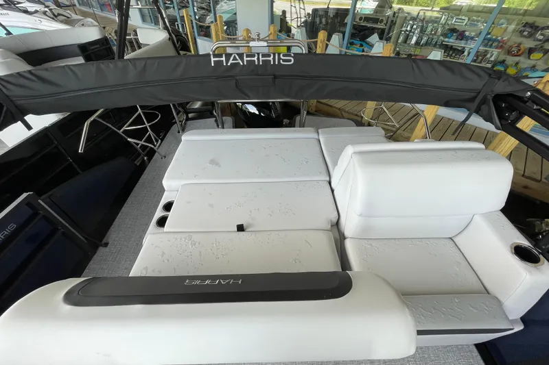 Slide: The Image of 2026 Harris Cruiser 210 SLDH boat interior with white seating and black canopy. - 8