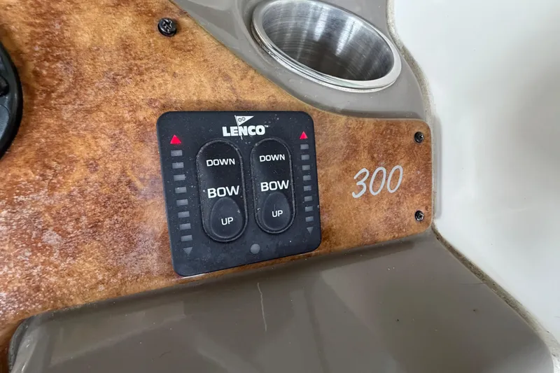 Slide: The Image of Control panel of a 2006 Rinker 300 Express Cruiser with Lenco trim tab switches. - 14