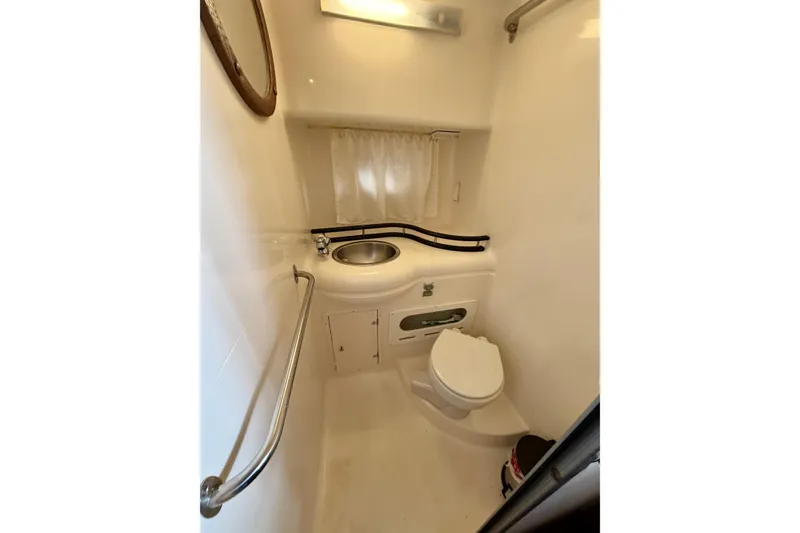 Slide: The Image of Bathroom interior of 2006 Rinker 300 Express Cruiser with sink and toilet. - 29