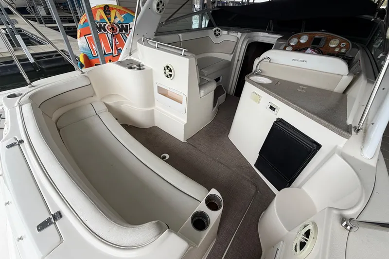 Slide: The Image of 2006 Rinker 300 Express Cruiser interior with seating, helm, and kitchenette. - 3