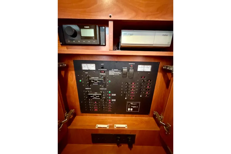 Slide: The Image of Control panel of a 2006 Rinker 300 Express Cruiser with audio system and switches. - 30