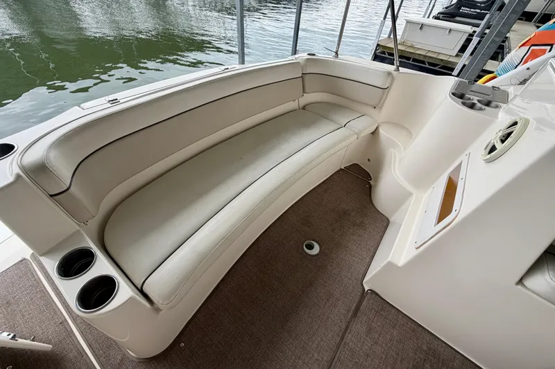 Slide: The Image of 2006 Rinker 300 Express Cruiser interior with curved seating and cup holders. - 4