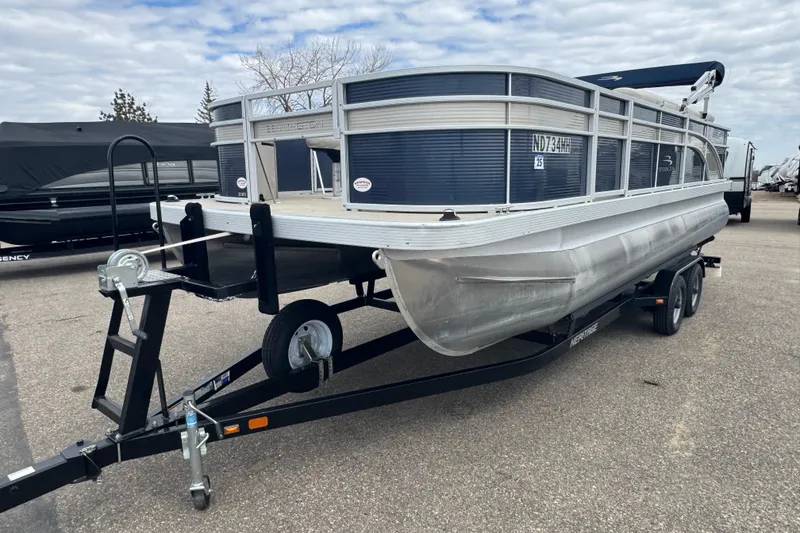 The Image of 2018 Bennington 22 SFX pontoon boat on trailer, parked outdoors. - 1
