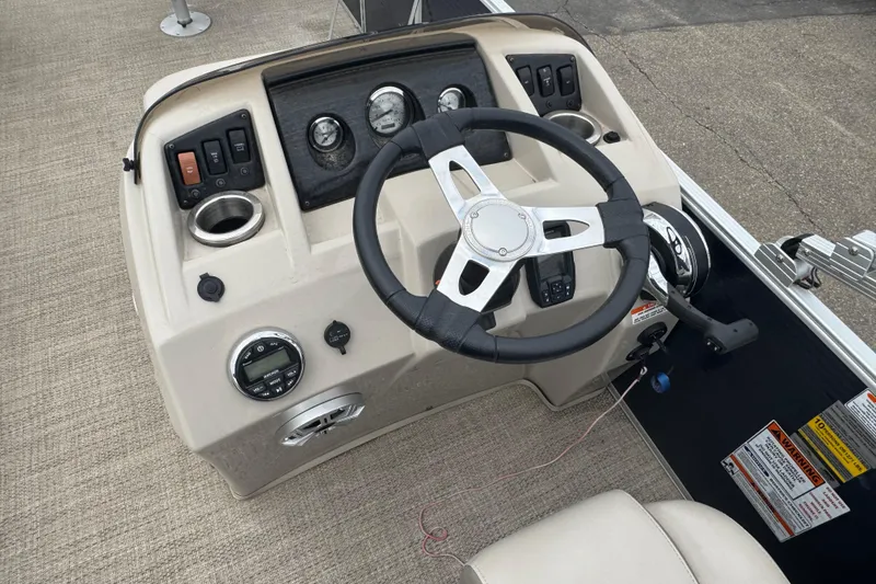 Slide: The Image of Steering console of a 2018 Bennington 22 SFX boat with gauges and controls. - 10