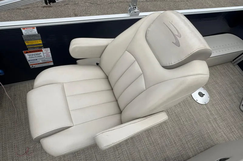 Slide: The Image of Luxurious captain's chair on 2018 Bennington 22 SFX pontoon boat, featuring plush white upholstery. - 11
