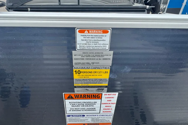 Slide: The Image of 2018 Bennington 22 SFX boat warning labels and capacity information. - 12