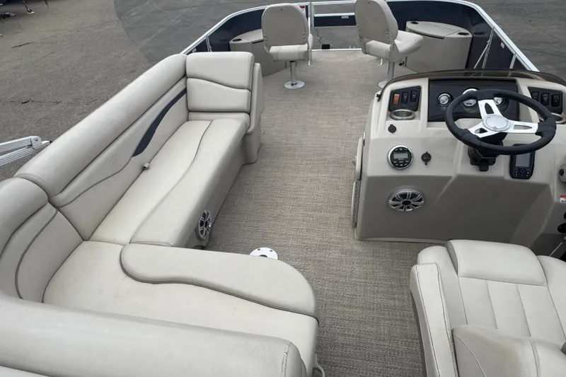 Slide: The Image of 2018 Bennington 22 SFX pontoon boat interior with beige seating and steering console. - 18