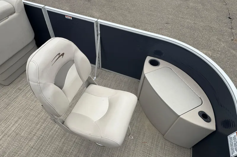 Slide: The Image of 2018 Bennington 22 SFX boat interior with beige seating and storage compartment. - 6