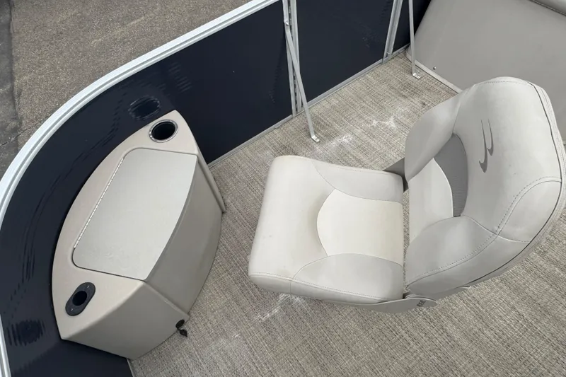 Slide: The Image of 2018 Bennington 22 SFX boat interior with cushioned seat and storage compartment. - 7
