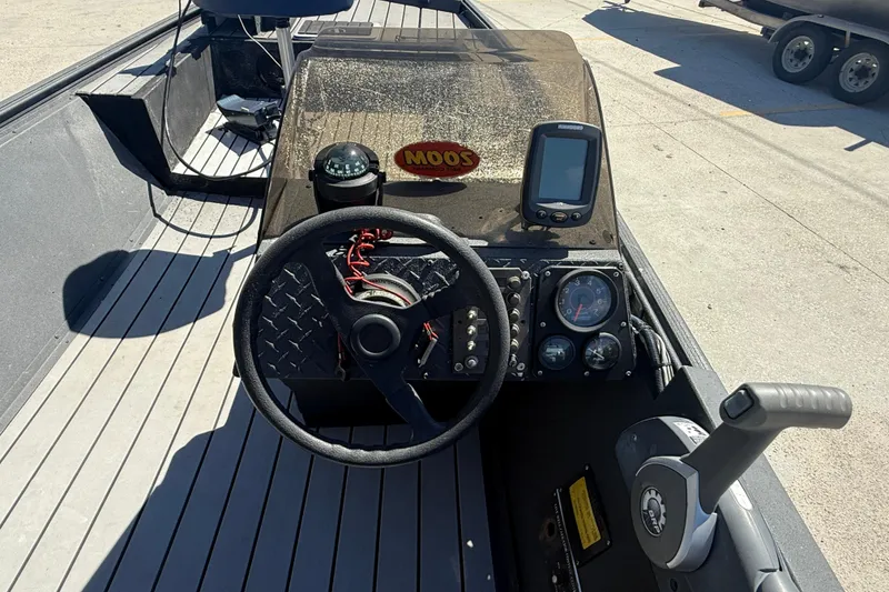 Slide: The Image of 1996 Duracraft 16 SC boat dashboard with steering wheel, gauges, and navigation equipment. - 11