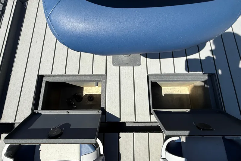 Slide: The Image of 1996 Duracraft 16 SC boat interior with open storage compartments and blue seating. - 12