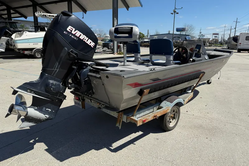 Slide: The Image of 1996 Duracraft 16 SC boat with Evinrude motor on trailer, parked outdoors. - 6