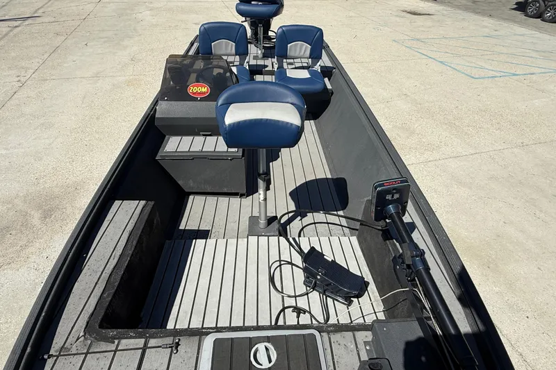 Slide: The Image of 1996 Duracraft 16 SC boat interior with blue seats and steering console. - 9