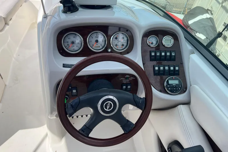 Slide: The Image of Steering console of a 2007 Chaparral 256 SSi boat with gauges and controls. - 10