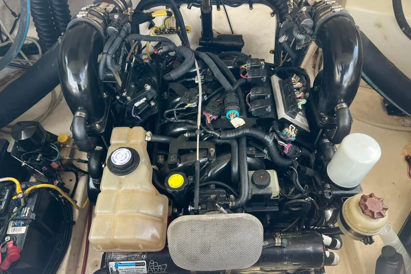 Slide: The Image of Engine compartment of a 2007 Chaparral 256 SSi boat, showcasing various components and wiring. - 11
