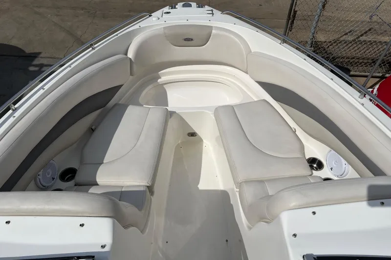 Slide: The Image of 2007 Chaparral 256 SSi boat interior with white seating and cup holders. - 14