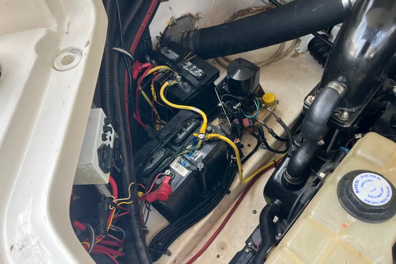 Slide: The Image of Engine compartment of a 2007 Chaparral 256 SSi boat, showing batteries and wiring. - 17