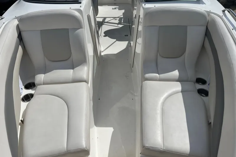 Slide: The Image of 2007 Chaparral 256 SSi boat interior with white leather seating and cup holders. - 4