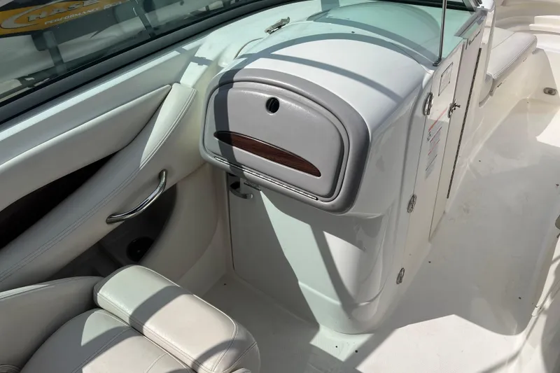 Slide: The Image of 2007 Chaparral 256 SSi boat interior with white seating and storage compartment. - 8