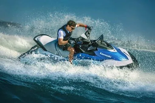 Slide: The Image of 2026 Kawasaki Jetski STX 160X speeding on water, creating dynamic splashes. - 3