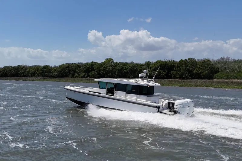 Slide: The Image of 2019 Axopar 37 XC Cross Cabin cruising on a sunny day. - 4