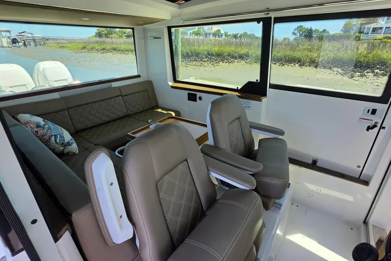 Slide: The Image of Interior of 2019 Axopar 37 XC Cross Cabin with seating and scenic windows. - 5