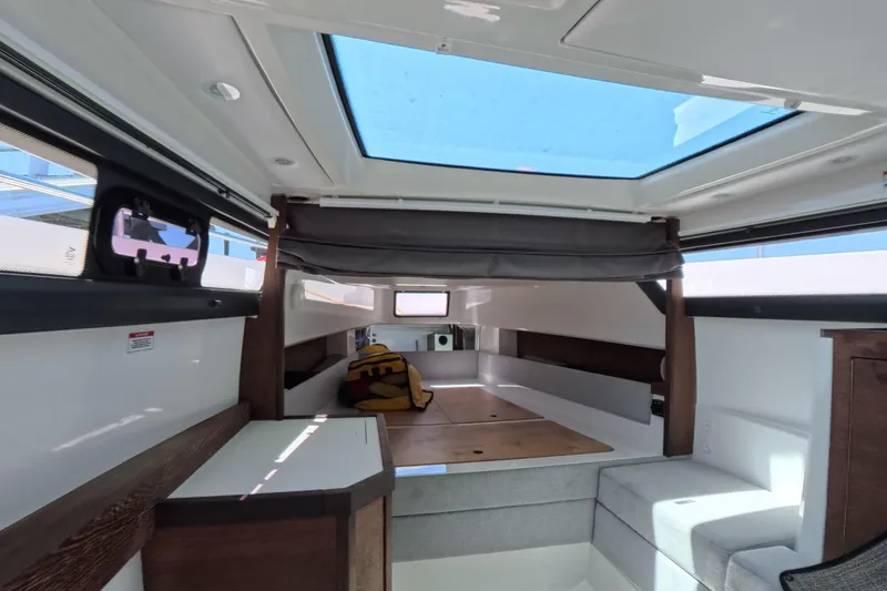 Slide: The Image of Interior of 2019 Axopar 37 XC Cross Cabin with skylight and modern seating. - 8