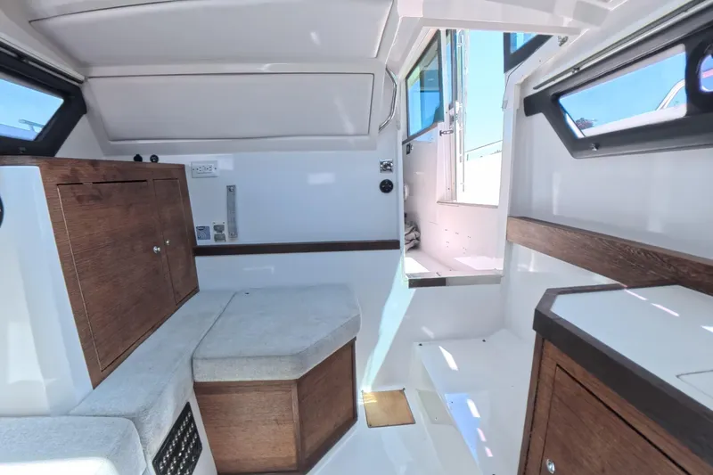 Slide: The Image of Interior of 2019 Axopar 37 XC Cross Cabin, featuring wood accents and seating area. - 9