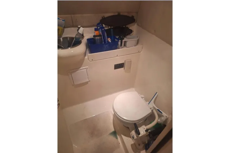 Slide: The Image of 2009 Glastron GT 249 boat bathroom with toilet and sink. - 12