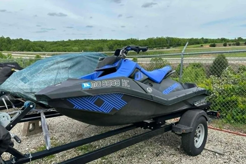 Slide: The Image of 2022 Sea-Doo Spark Trixx 2up jet ski on trailer, parked outdoors. - 14