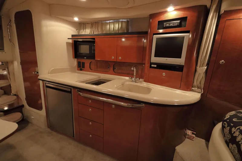Slide: The Image of Interior of 2004 Sea Ray 340 Sundancer with kitchen and TV. - 14