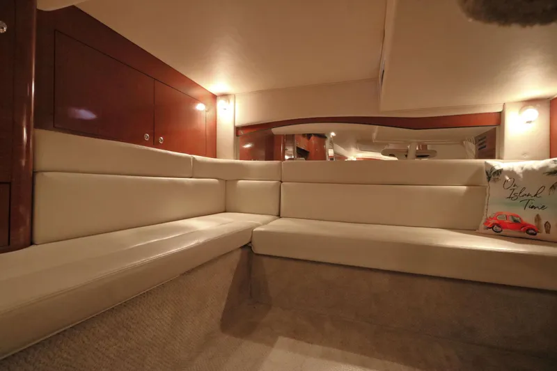 Slide: The Image of Interior of 2004 Sea Ray 340 Sundancer yacht with beige seating and decorative pillow. - 16