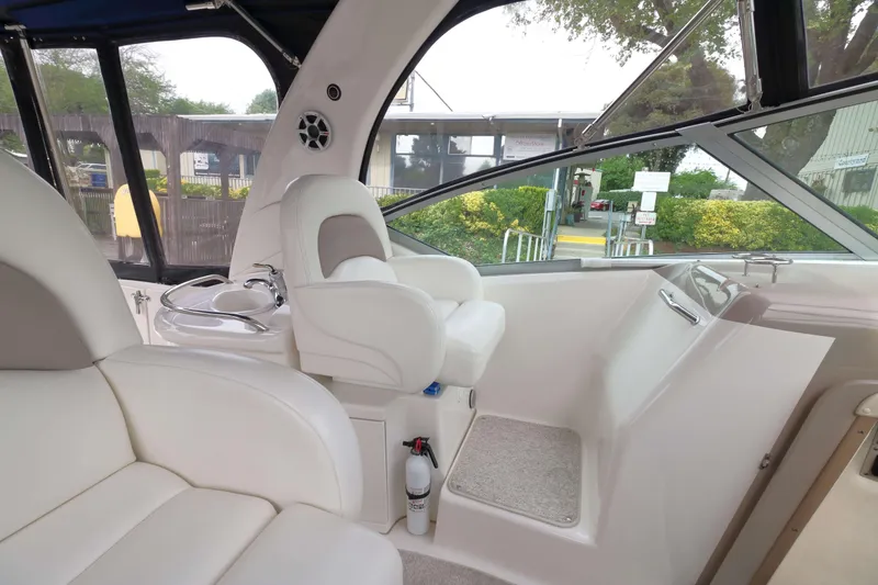 Slide: The Image of 2004 Sea Ray 340 Sundancer cockpit with white seating and helm station. - 5